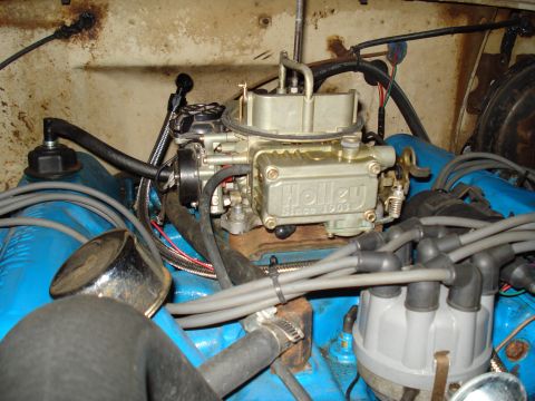 1967 Ford F-250 - Engine bay detail a Holley carburetor and distributor with visible wiring and hoses.
