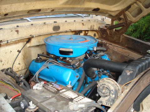 1967 Ford F-250 - The engine bay of a 1967 Ford F-250 shows its blue valve covers and air cleaner assembly.