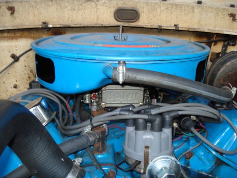 1967 Ford F-250 - Close-up of an engine bay showing a Holley carburetor and blue air cleaner.