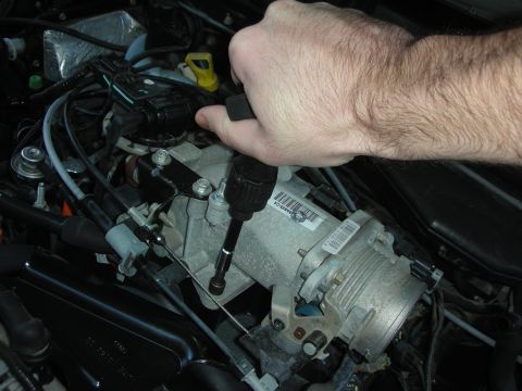 2004 Ford Crown Victoria - Installing a new throttle body assembly onto an engine. A label with a part number is visible on the component.