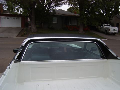 1973 Ford Ranchero - Rear view of a 1973 Ford Ranchero, showing its white bed and black vinyl roof.