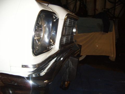1973 Ford Ranchero - Close-up of a white vehicle's front end, showing the grille and headlight assembly.