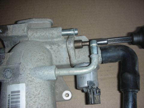 2004 Ford Crown Victoria - Close-up of a Ford intake manifold part with attached hoses and connector.