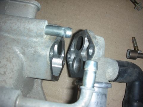 2004 Ford Crown Victoria - Two aluminum intake manifold parts are shown, possibly for an engine modification or repair.