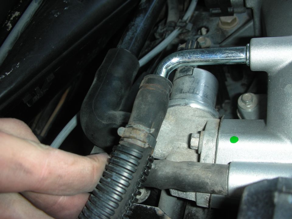 Engine intake manifold and throttle body with hoses and a hand