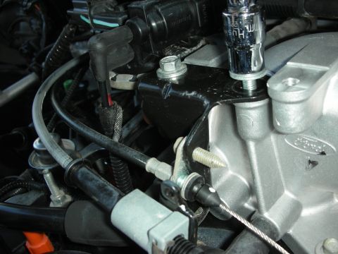 2004 Ford Crown Victoria - Socket wrench working on an engine intake manifold and throttle body assembly.