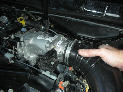 2004 Ford Crown Victoria - Installation of an aftermarket throttle body and air intake tube in a Ford engine bay.