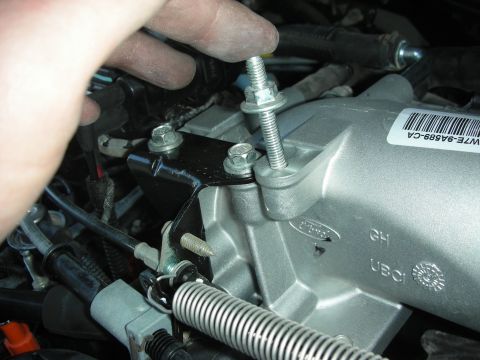 2004 Ford Crown Victoria - Installing a new engine part, likely a throttle body or intake manifold component.