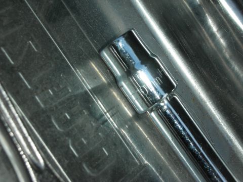 2004 Ford Crown Victoria - A 10mm socket wrench is shown on a ribbed metal surface, likely a toolbox or tray.
