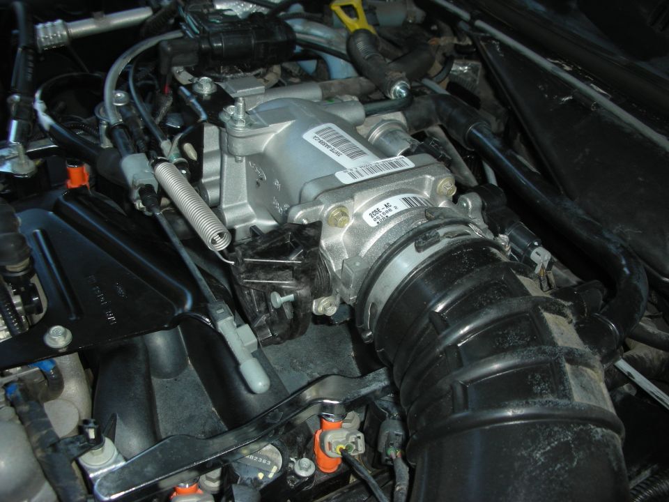 Engine intake manifold and throttle body assembly with visible part numbers and labels