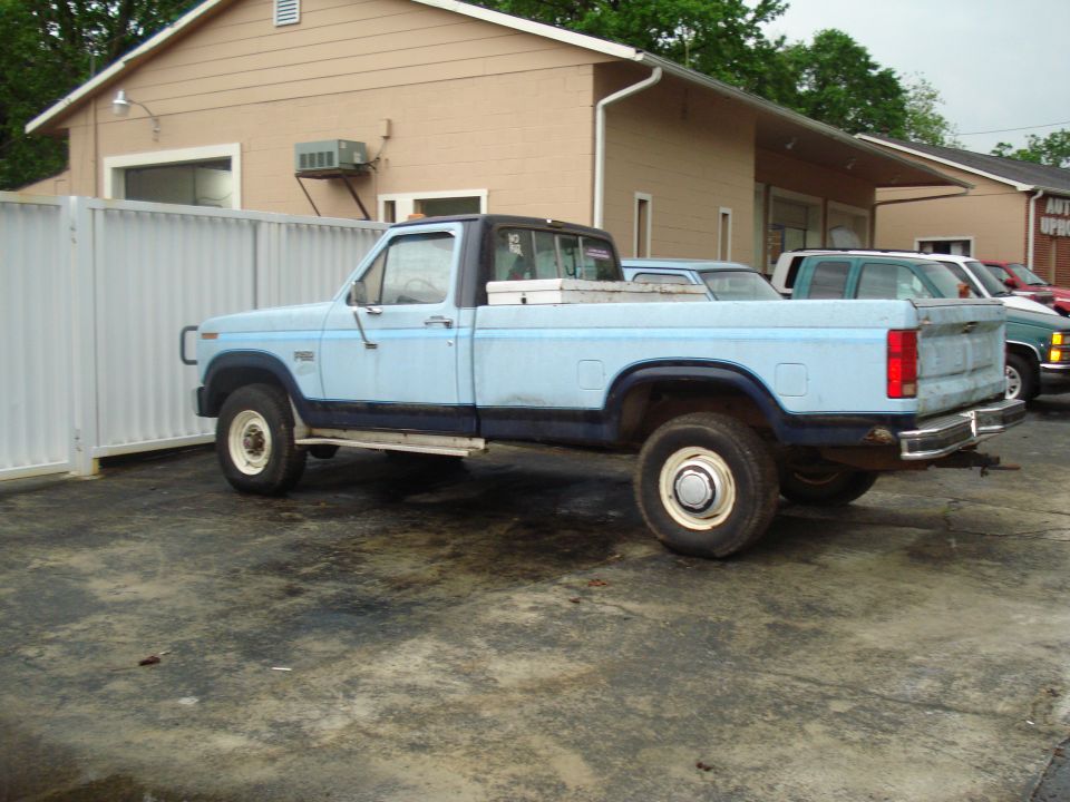 Light blue pickup truck, side view, 1980s body style