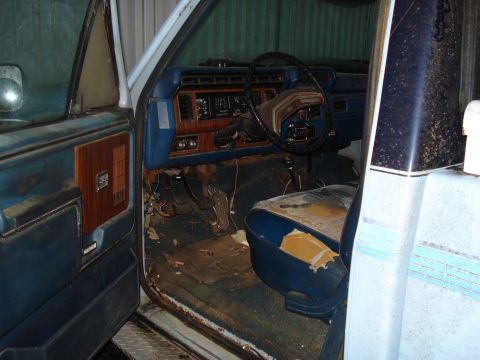 1967 Ford F-250 - Interior of a light blue pickup truck, likely from the early 1980s, showing the dashboard, steering wheel, and driver's seat.