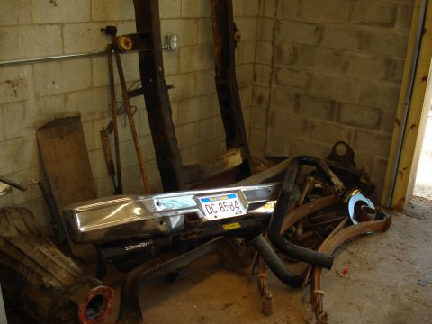 1967 Ford F-250 - A chrome bumper with a DC 8584 license plate is visible among various vehicle parts.