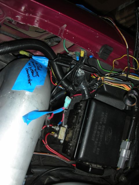 1992 Ford Crown Victoria - Engine bay wiring and fuse box with a label on blue tape.