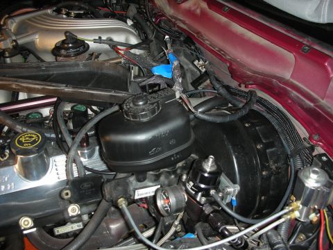 1992 Ford Crown Victoria - Close-up view of the engine bay in a 1992 Ford Crown Victoria, highlighting components related to an intercooler project.