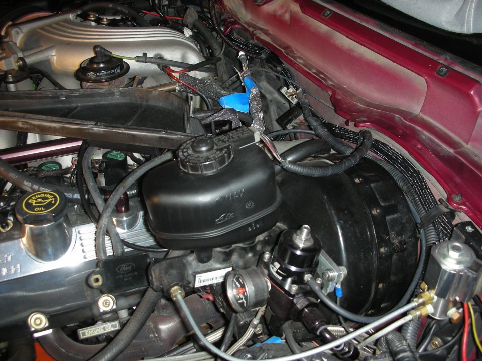 Engine bay of a 1992 Ford Crown Victoria showing intercooler project parts and a Ford badge