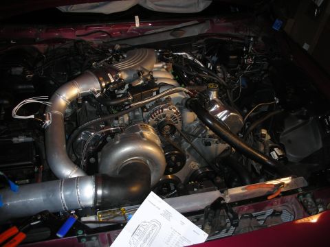1992 Ford Crown Victoria - Custom turbocharger installation in an engine bay, with various components and tools present.