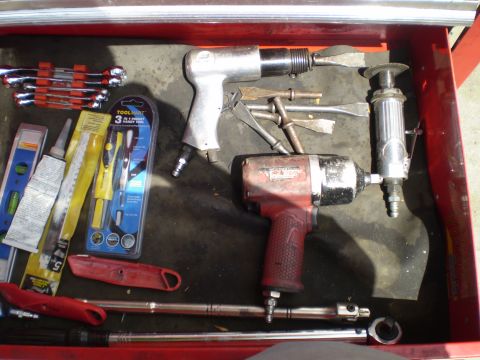 1969 Ford F-250 - A collection of pneumatic and hand tools are organized within a red toolbox drawer.