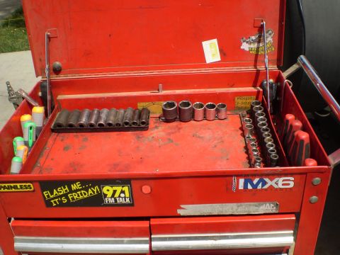 1969 Ford F-250 - Red toolbox containing a collection of sockets and tools, with several stickers on the exterior.