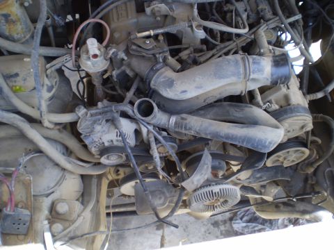 1969 Ford F-250 - Close-up view of a vehicle's engine bay components, including the fan and alternator.
