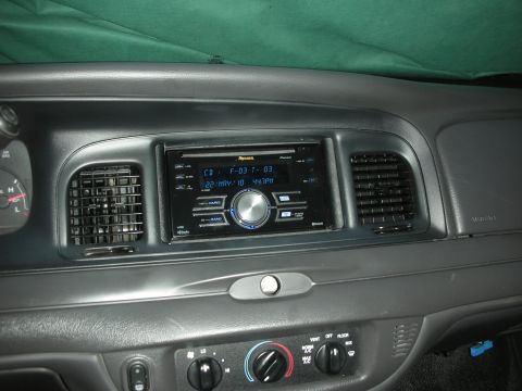 2004 Ford Crown Victoria - Gray dash center stack fitted with a Pioneer Premier double-DIN CD receiver whose blue display reads "CD F-03 T-03" and "22/MAY/10 4:47PM",…