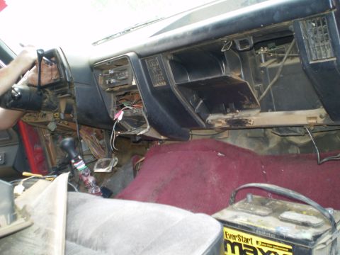 1969 Ford F-250 - The dashboard of a truck is disassembled, revealing wiring and interior components.