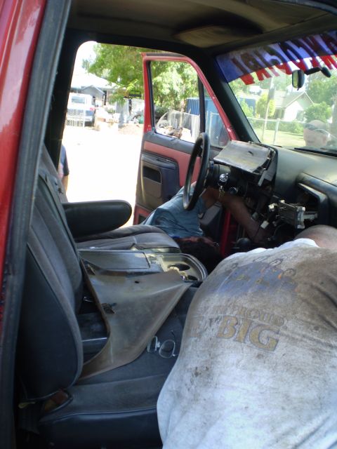1969 Ford F-250 - Working on the interior of a red truck, dashboard removed, wiring exposed.
