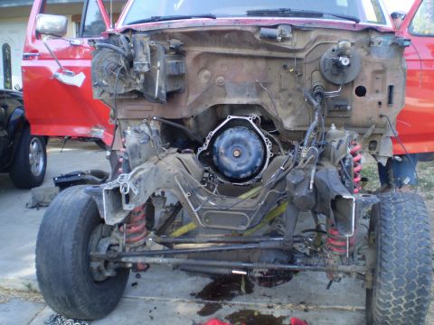 1969 Ford F-250 - Truck chassis undergoing work, transmission removed. Visible suspension and frame details.