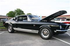 1968 Shelby GT500 - This black 1968 Shelby GT500 is shown from a three-quarter front angle with its hood open.