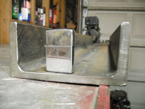 1991 Ford Bronco - A Zippo lighter rests inside a metal beam, possibly for scale or as part of a project.