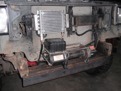 1991 Ford Bronco - Aftermarket winch and transmission cooler installed on the front of a vehicle.