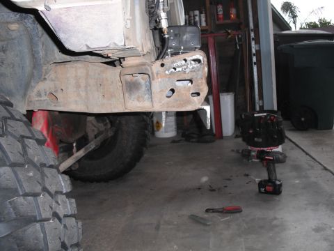 1991 Ford Bronco - Close-up view of a heavily rusted vehicle frame and a large off-road tire, suggesting off-road modification or repair.