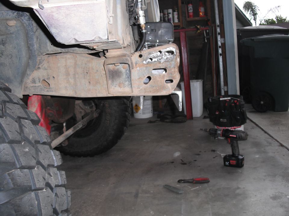 Rusted frame and large tire, part of a vehicle