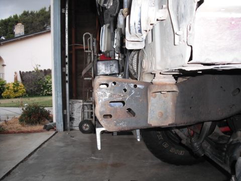 1991 Ford Bronco - Close-up of a rusted vehicle frame and bumper bracket, showing wear and tear.