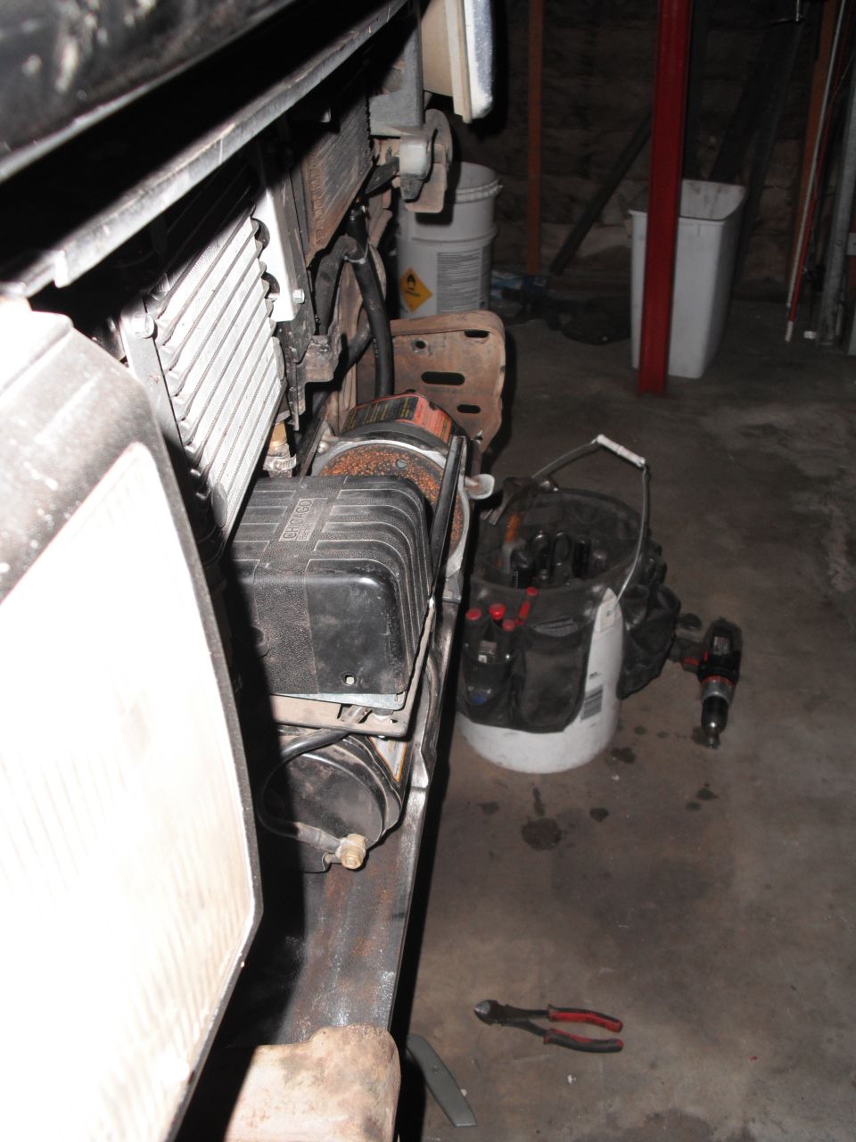 Winch and radiator assembly mounted on vehicle frame