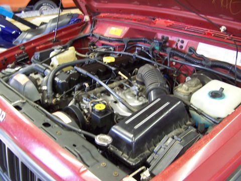 1991 Jeep Comanche - Engine compartment of a 1991 Jeep Comanche, showing the motor and associated components.
