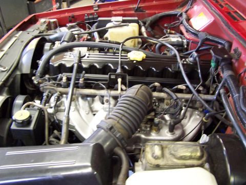 1991 Jeep Comanche - Close-up view of the engine compartment, detailing the intricate network of hoses and wiring within the vehicle.