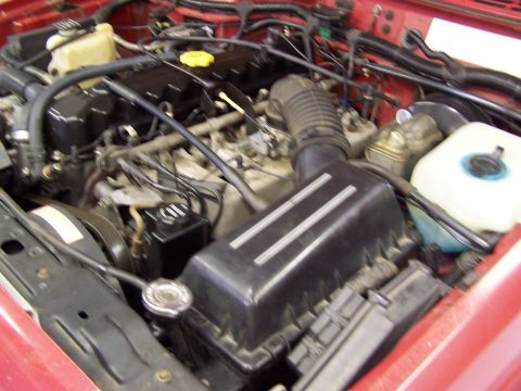 1991 Jeep Comanche - Close-up view of a Jeep engine bay, showing the air intake and associated components.