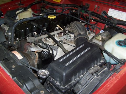 1991 Jeep Comanche - Close-up view of the engine compartment, showing various mechanical components and wiring.
