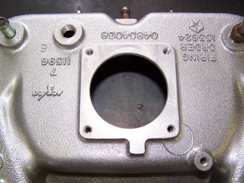 1991 Jeep Comanche - Close-up of an engine intake manifold showing various casting numbers and the Chrysler pentastar logo.