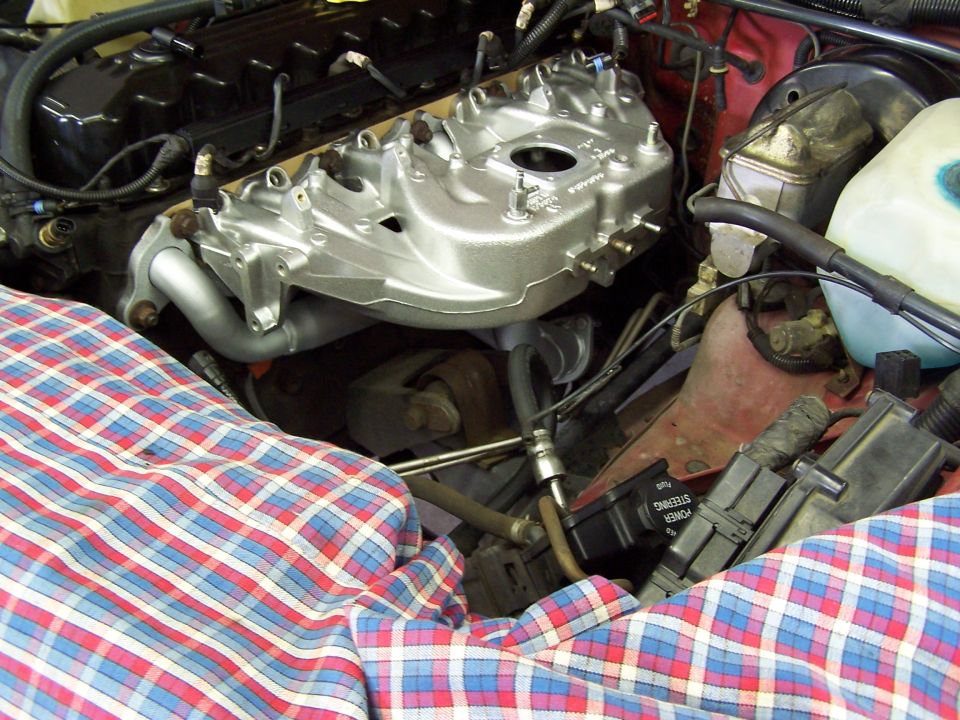 engine intake manifold and parts of engine bay covered with plaid cloth