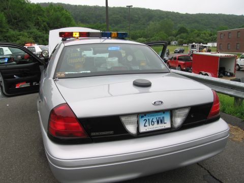 1991 Ford LTD Crown Victoria - Rear view of a silver Ford Crown Victoria police interceptor marked as a state trooper car, showing a Connecticut plate reading 216-WWL.