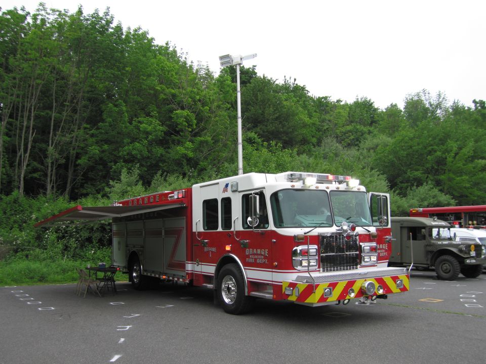 Orange Fire Dept rescue truck with side compartment door open