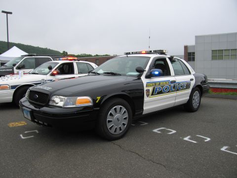 1991 Ford LTD Crown Victoria - black-and-white Town of Berlin Police Ford Crown Victoria cruiser shown front three-quarter with light bar, parked in a lot.