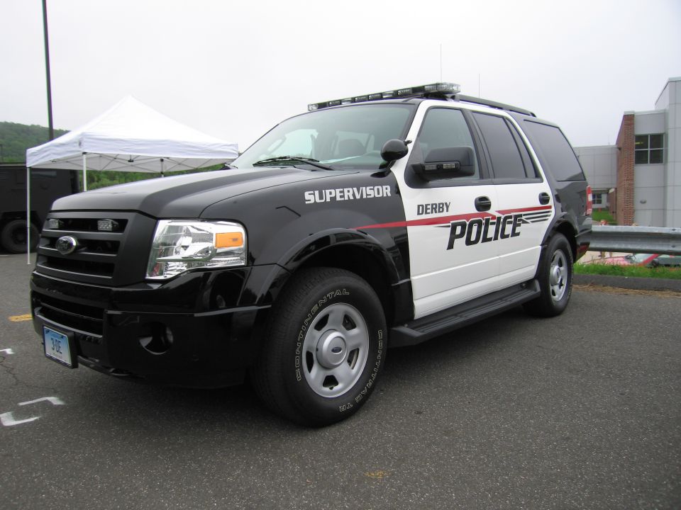Black and white Ford Expedition Derby Police Supervisor SUV, front three-quarter view