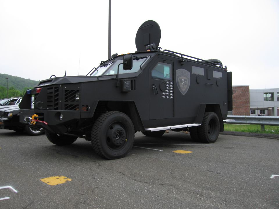 Black armored SWAT police truck with turret, front three-quarter view
