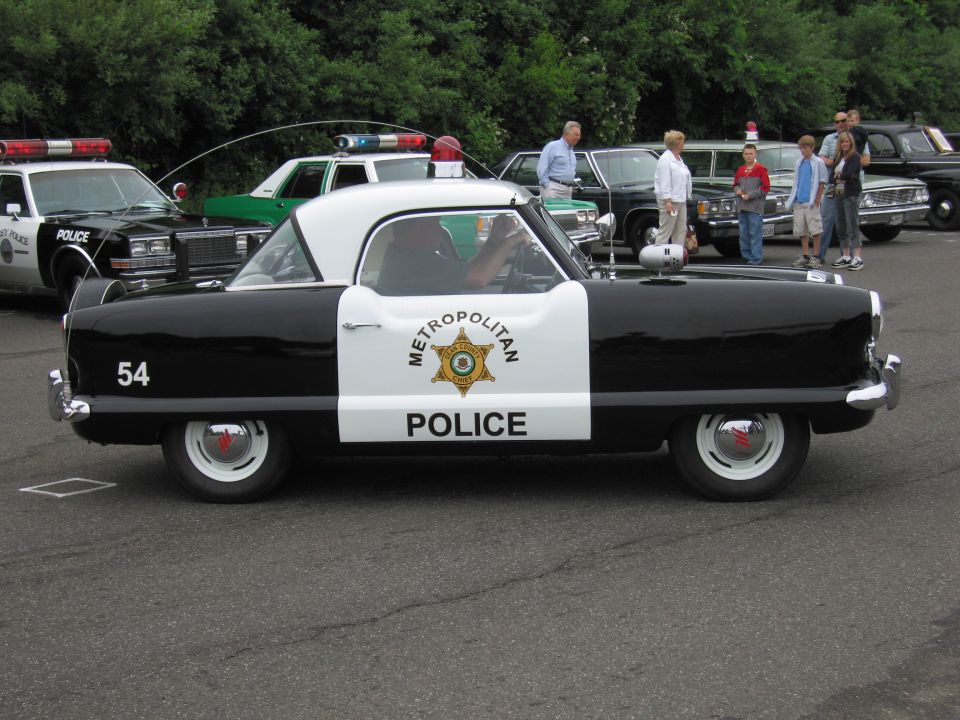Black and white Nash Metropolitan painted as Metropolitan Police car number 54