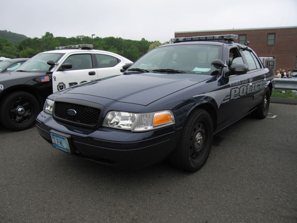 Dark blue Ford Crown Victoria police cruiser, front three-quarter view