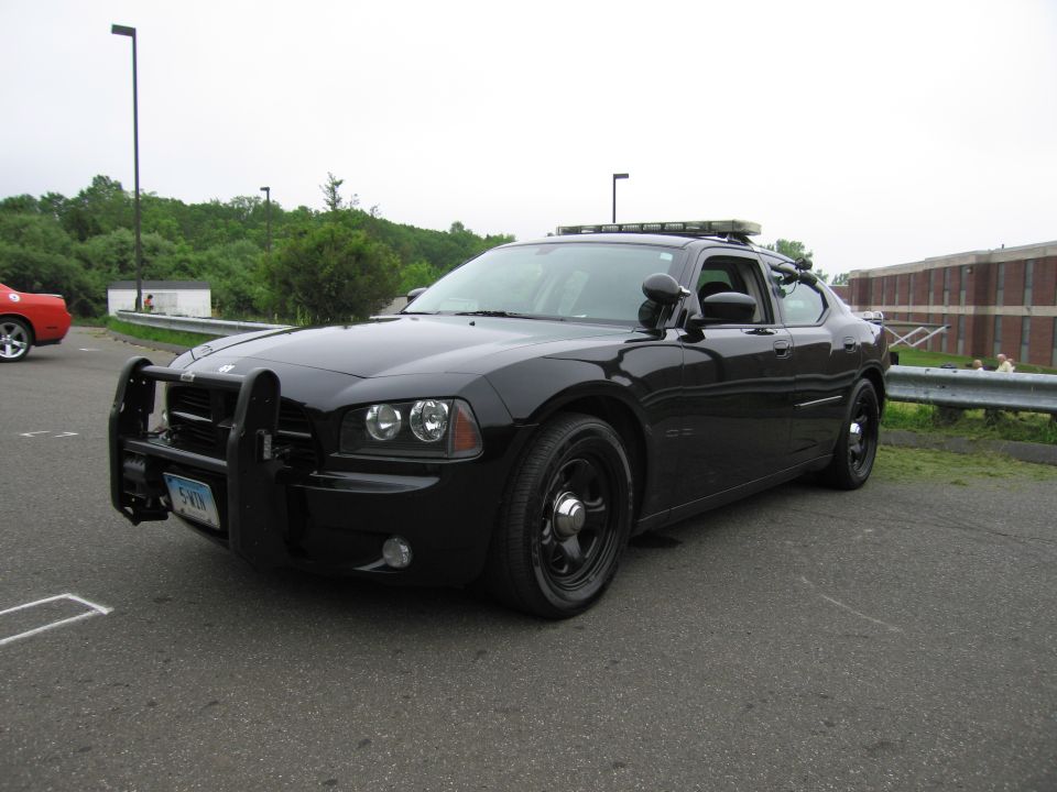 All-black Dodge Charger unmarked police car with push bar, front three-quarter view