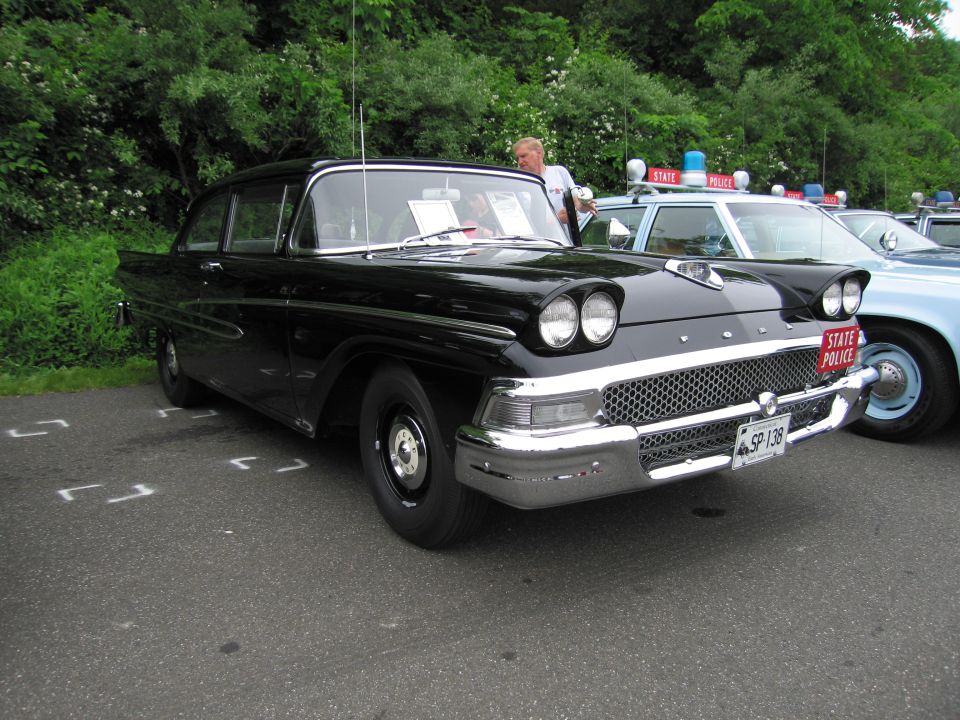 Black 1958 Ford State Police sedan with quad headlights, front three-quarter
